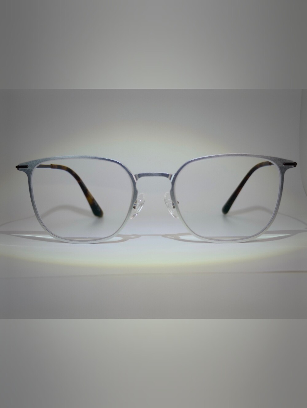 Density. Titanium Frame Silver, Dark Brown Temple. Square.